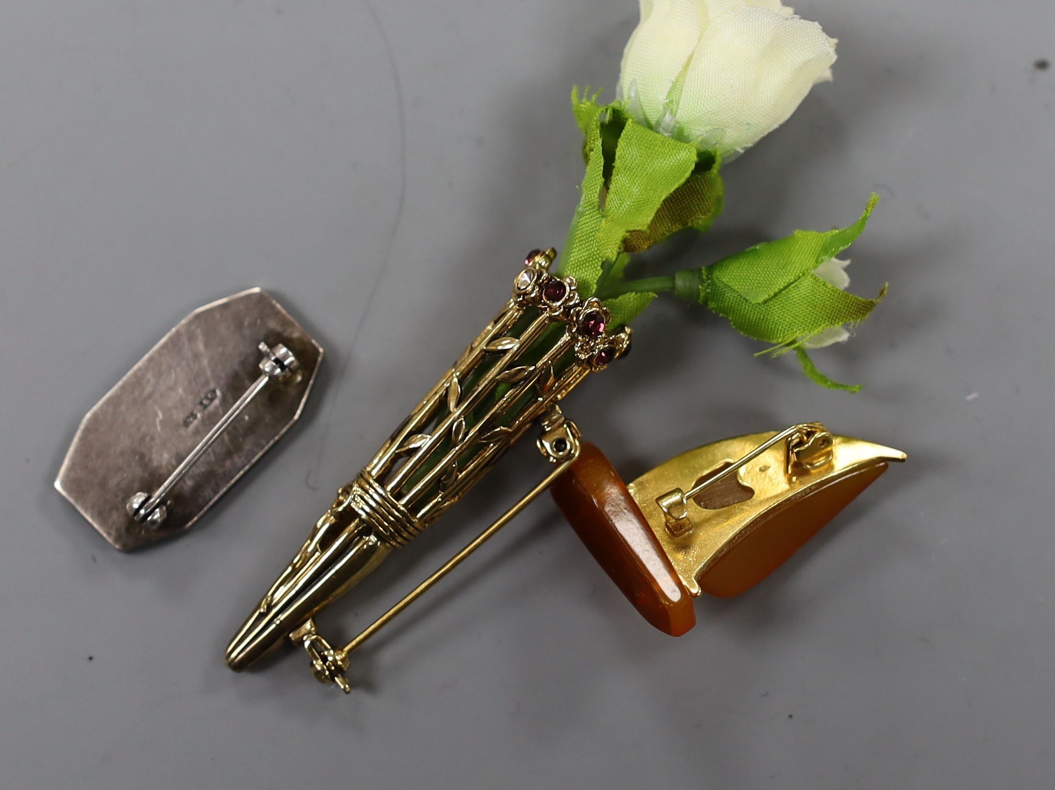 An Art Deco 925, black onyx, chrysoprase? and marcasite set octagonal brooch, 30mm, an amberoid yacht brooch and a gilt metal and paste set posy holder brooch.